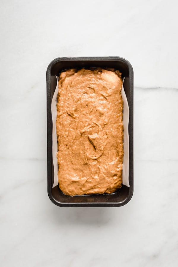 pumpkin bread batter in a loaf pan