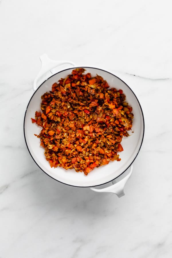 cooked down vegetables in a white pot