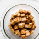 a bowl of cooked tofu cubes