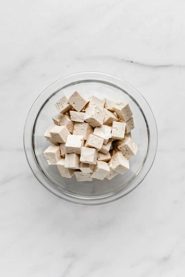 cubes of tofu in a clear mixing bowl