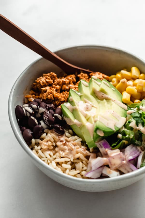 a chipotle sofritas bowl with a drizzle of chipotle mayo on top