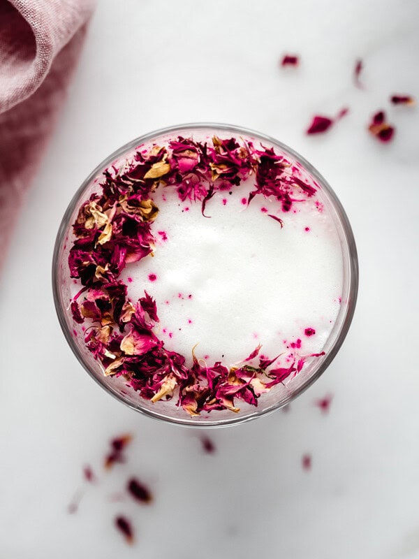 a hibiscus rose latte topped with rose petals