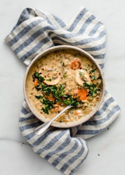 wild rice soup in a bowl on top of a blue striped napkin