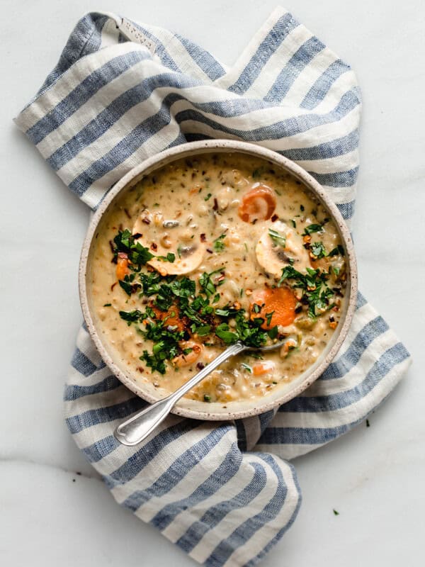 wild rice soup in a bowl on top of a blue striped napkin