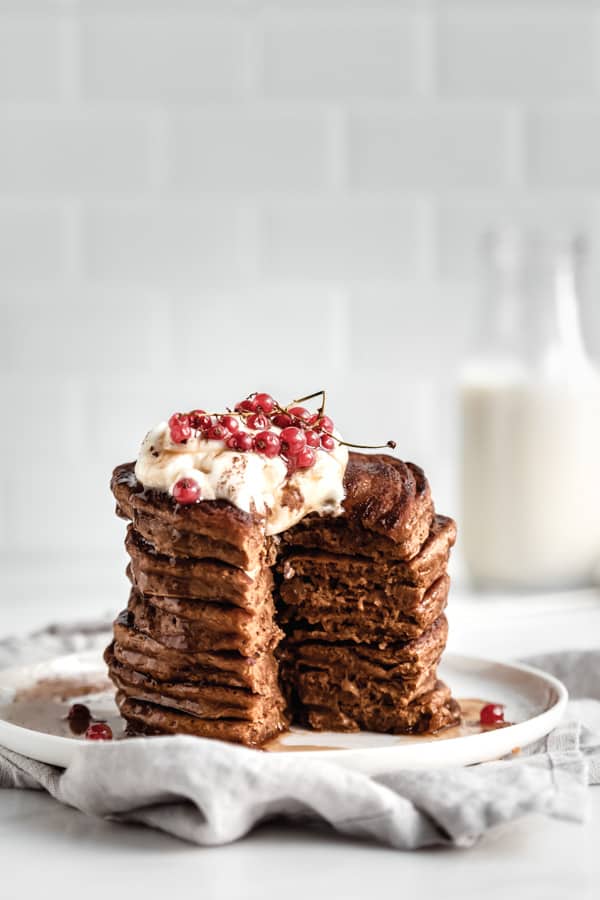 stacked gingerbread pancakes with a slice cut out of them