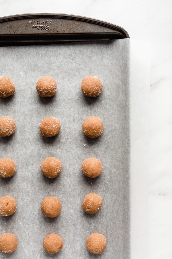 unbaked peanut butter cookies on a baking sheet
