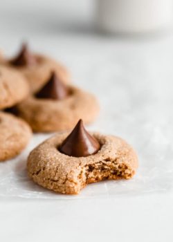 a peanut butter blossom cookie with a bite taken out of it