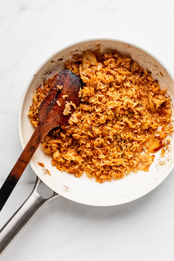 A white pan with kimchi fried rice in it