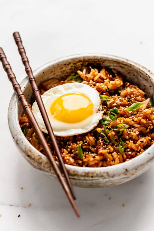 a side angle of a bowl with kimchi fried rice in it