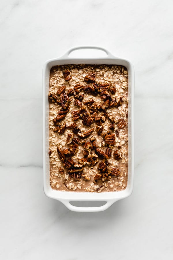 unbaked pecan pie oatmeal in a white baking dish