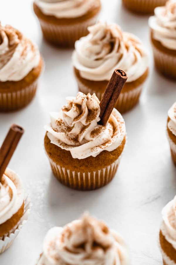 pumpkin spice latte cupcakes topped with frosting and cinnamon sticks