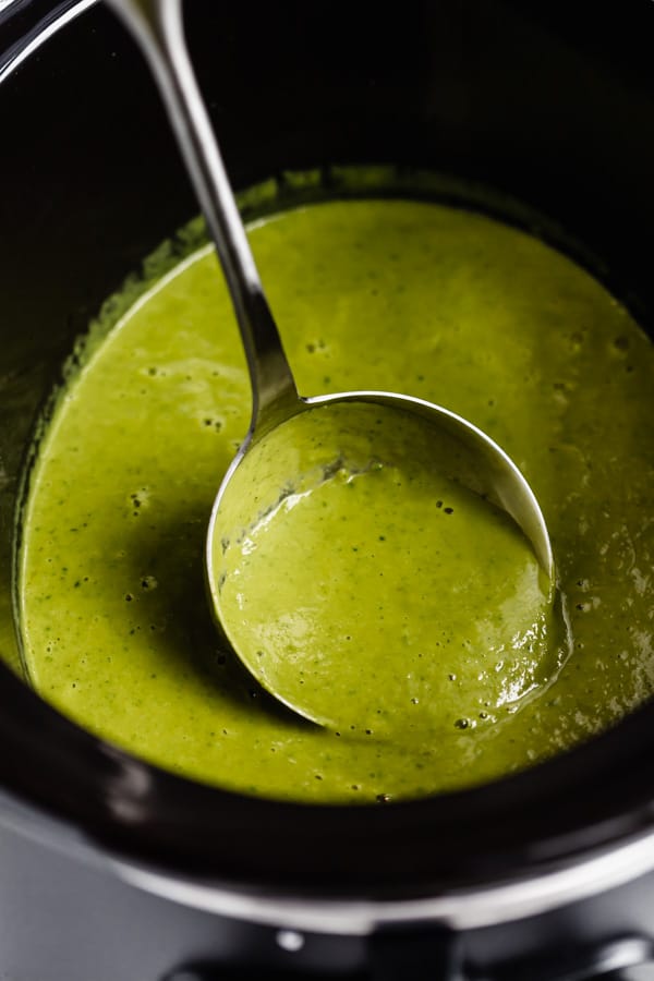 a ladle scooping up broccoli soup from a crockpot