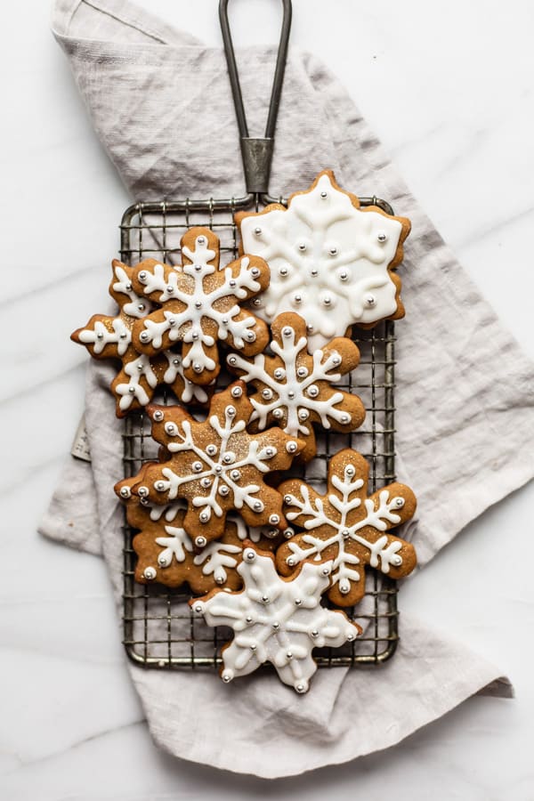 snowflake gingerbread cookies on a cooling rack and napkin