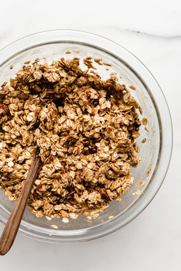 a clear mixing bowl with banana bread granola in it