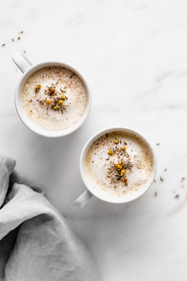 two lavender London Fogs on a white marble board with a napkin on the side