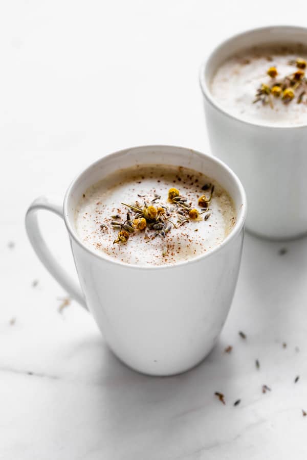 Two London fogs in white mugs on a marble board