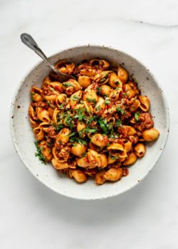 A top down of a white speckeld pasta bowl filled with vegan taco pasta