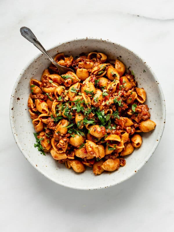 A top down of a white speckeld pasta bowl filled with vegan taco pasta