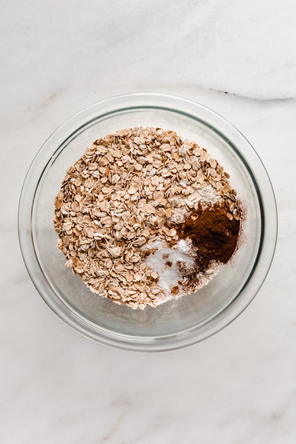 a bowl of oats and cinnamon in a mixing bowl