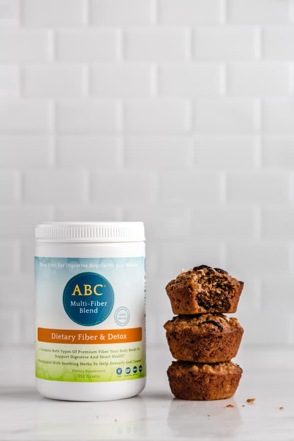 a bottle of nutritional brand fiber blend with a stack of 3 oatmeal cups next to it