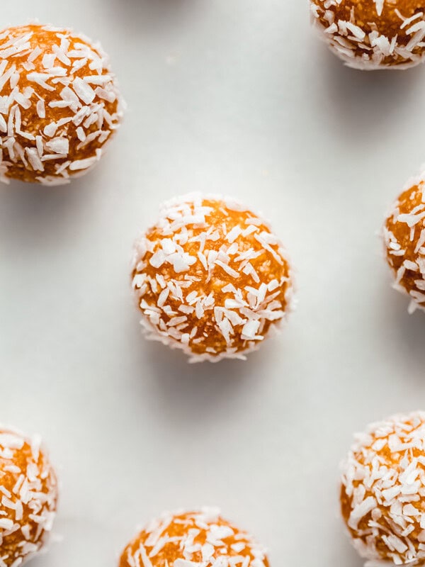 an apricot energy ball with shredded coconut