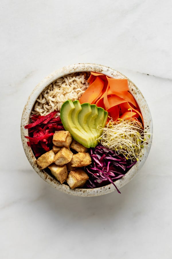a dragon bowl with tofu and veggies in it