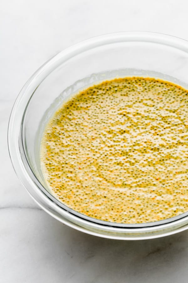a clear mixing bowl with golden milk latte chia pudding in it