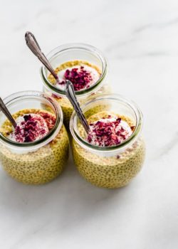 three jars of chia golden milk latte chia pudding topped with yogurt and rose petals