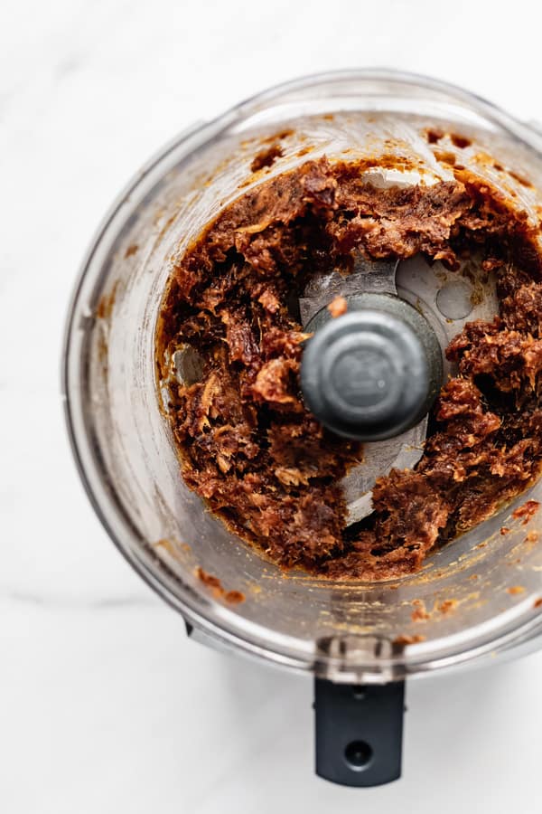 a food processor with date paste in it
