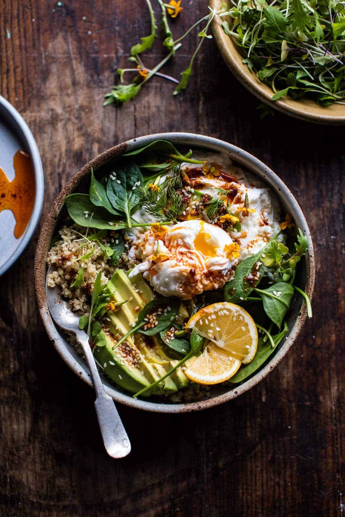 A bowl of Turkish eggs with greens and lemon