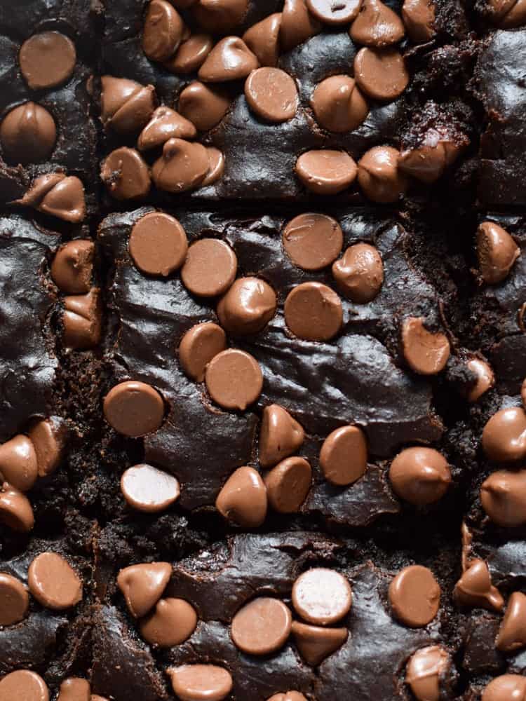 freshly baked black bean brownies made with a can of beans, topped with milk chocolate chips and cut into squares