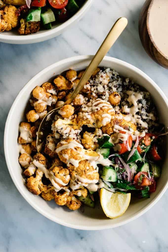 A cauliflower shawarma bowl with tahini sauce drizzled on top