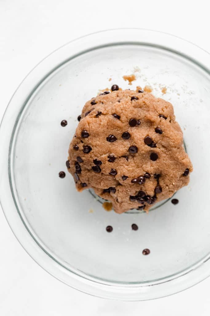healthy raw cookie dough in a clear mixing bowl
