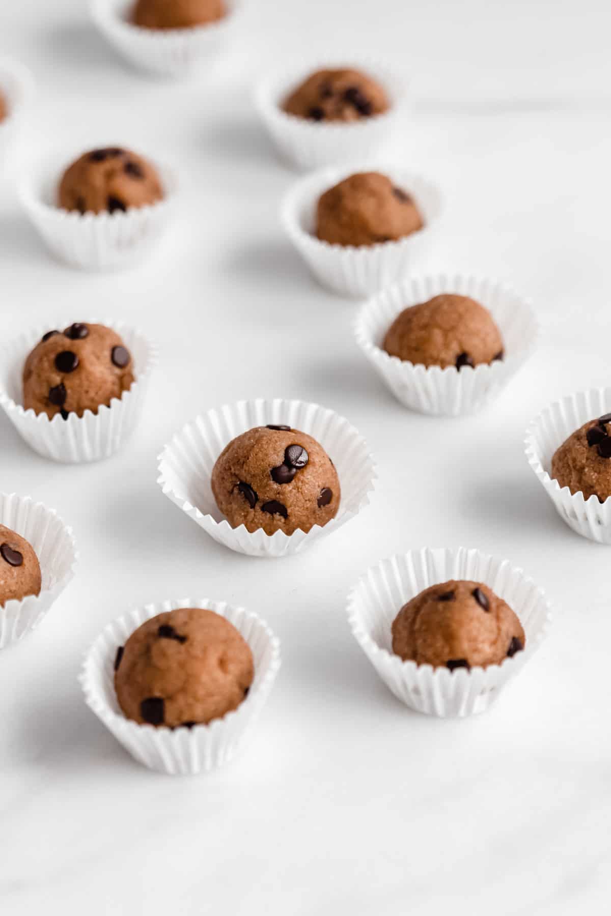 Chocolate chip cookie dough balls on a marble counter