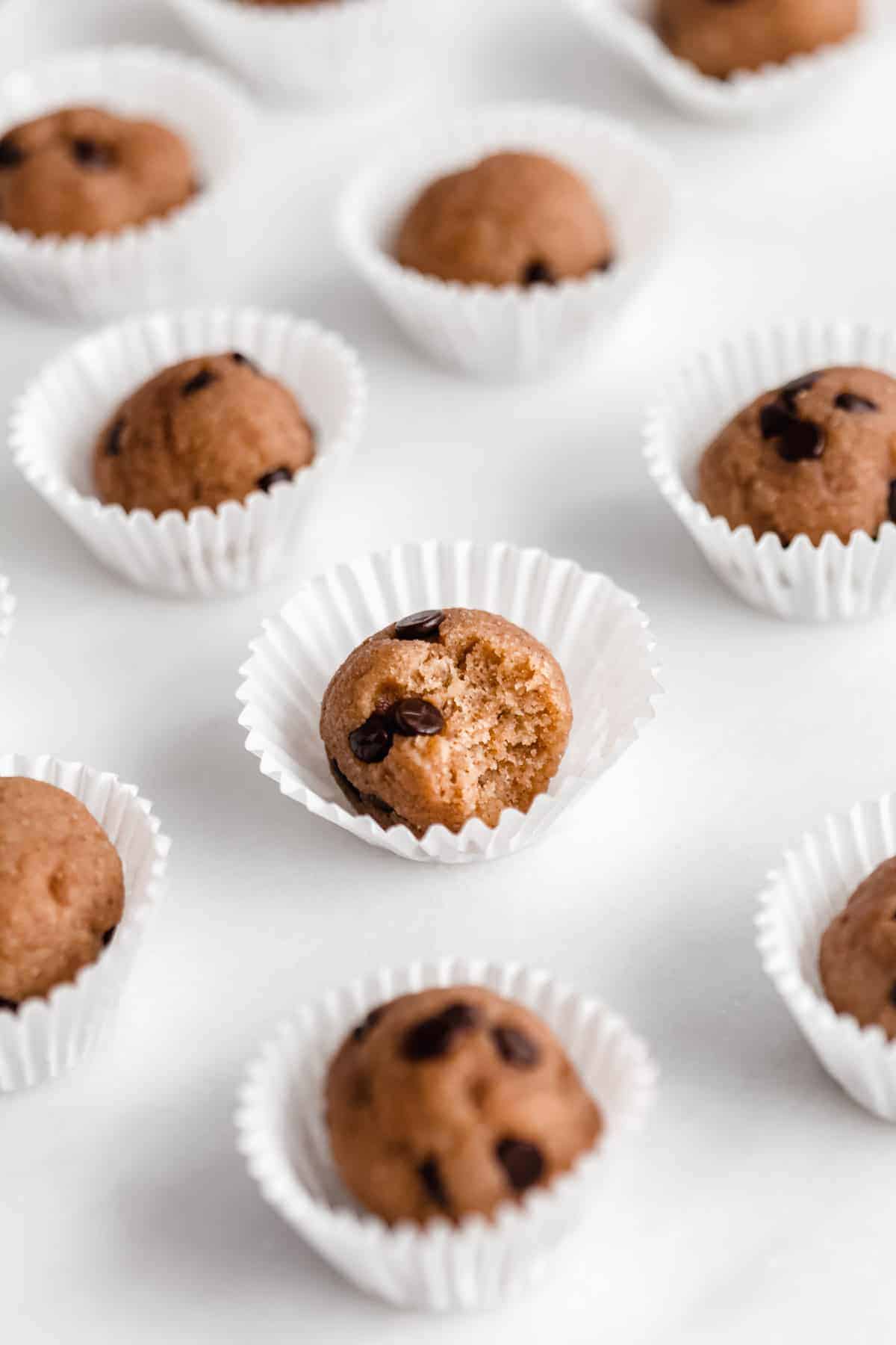 Chocolate chip cookie dough ball with a bite taken out of it