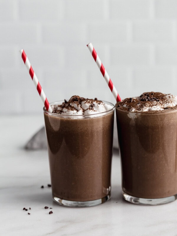 two glasses of frozen hot chocolate with red straws in them