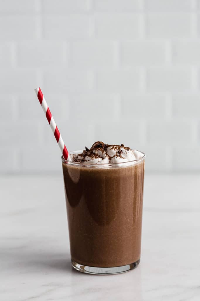 frozen hot chocolate in a glass with coconut whipped cream