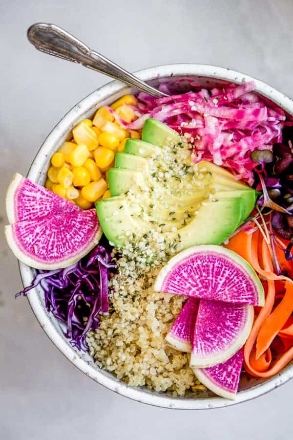 A rainbow buddha bowl with red cabbage, radishes and beets