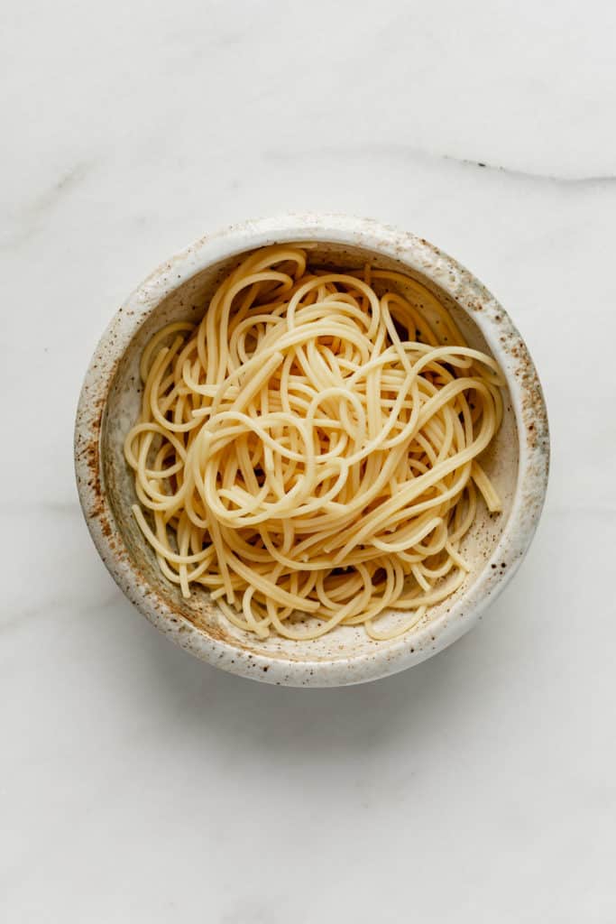 spaghetti noodles in a white ceramic bowl