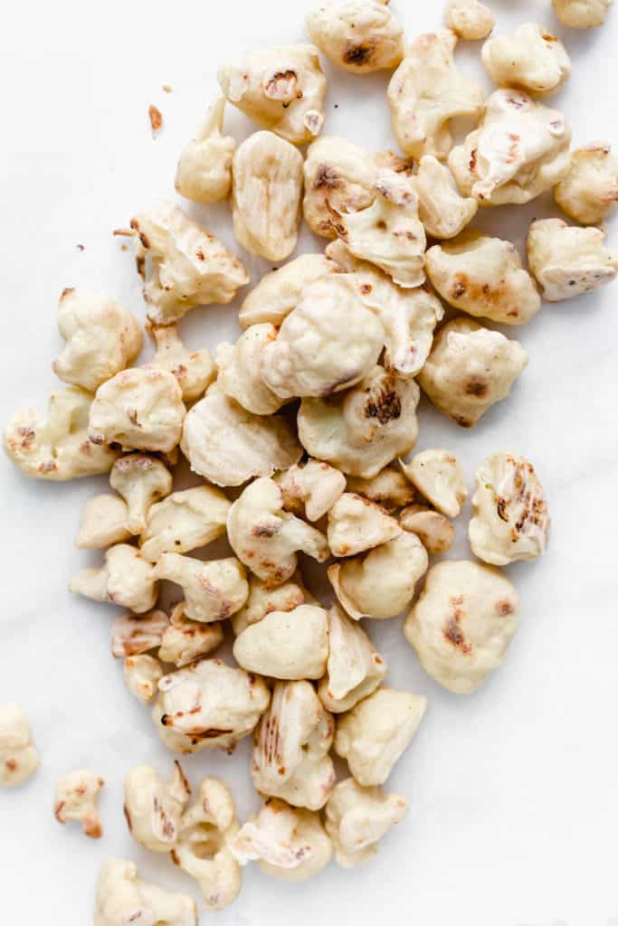 battered roasted cauliflower on a marble board