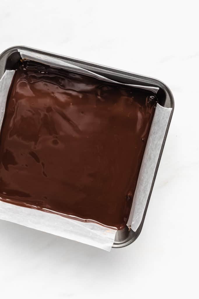 a silver 8x8 inch pan with chocolate in it