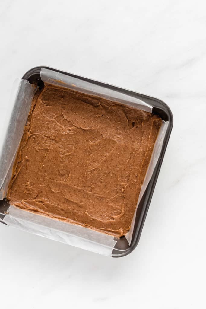 an 8x8 inch pan with date caramel in it