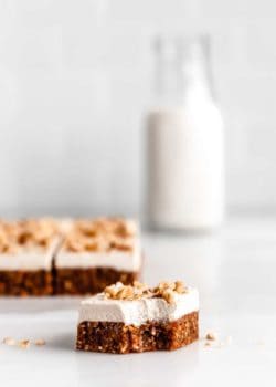 a square of raw carrot cake with a bite taken out of it