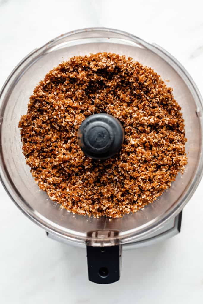 a crumbly raw mixture of dates and nuts in a food processor