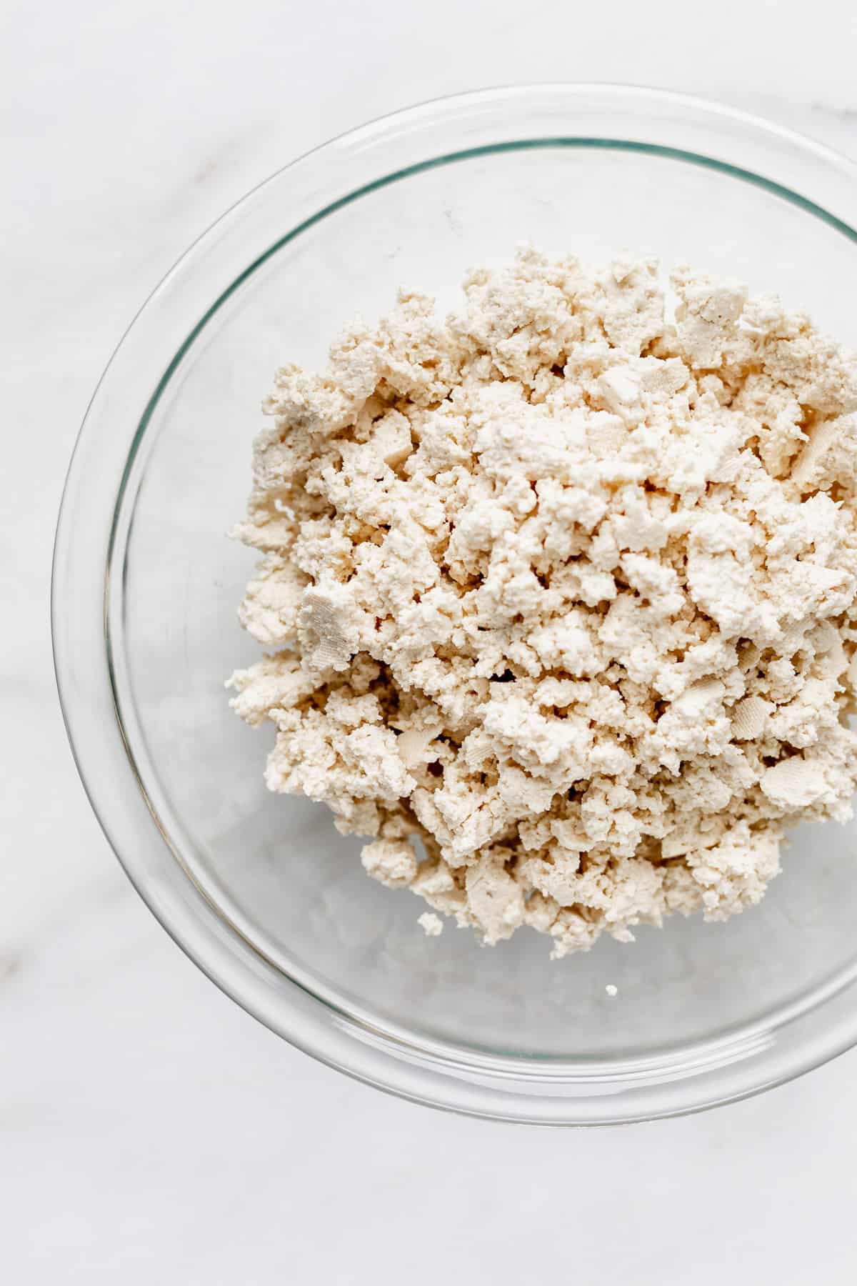 tofu crumbled up in a clear mixing bowl