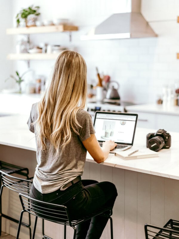 girl sitting at kitchen island on a laptop