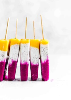 5 tropical coconut chia popsicles stacked next to each other