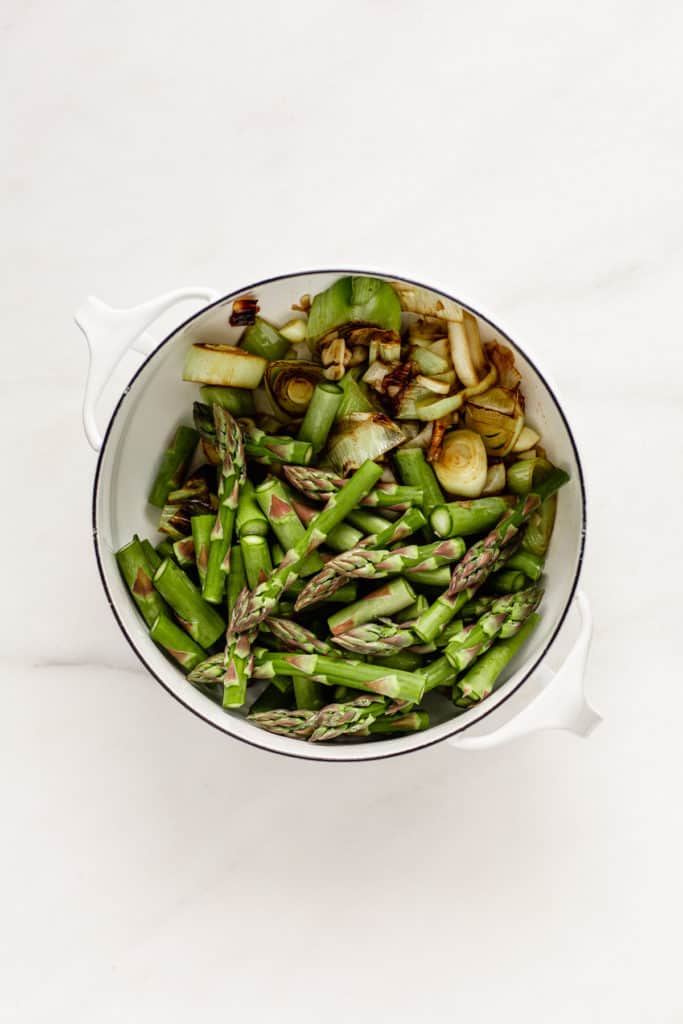 leeks and asparagus in a white pot