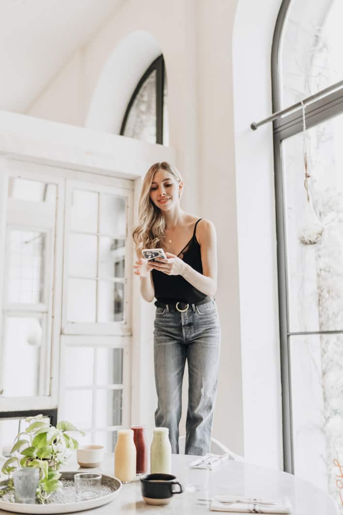 girl standing taking photos of smoothies