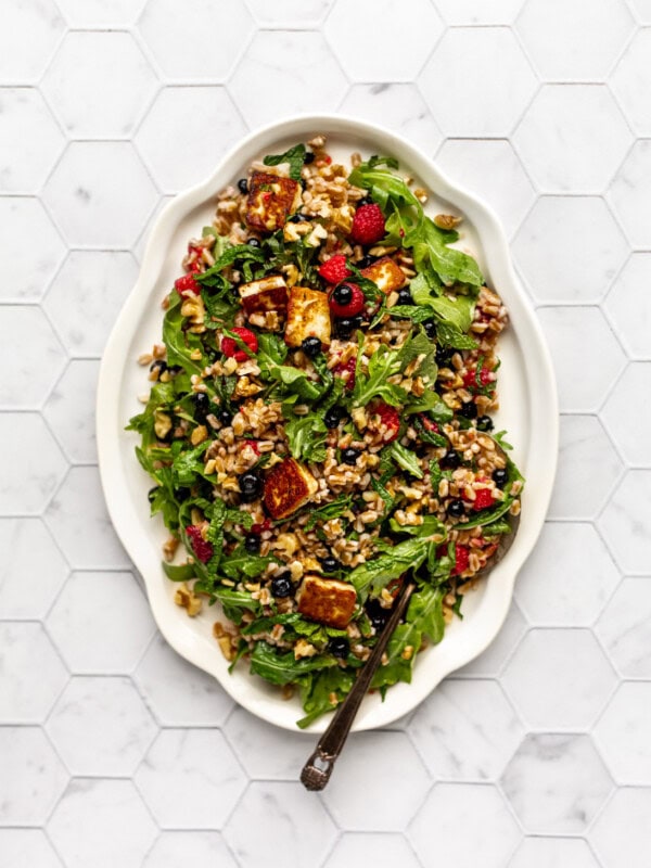 Farro and halloumi salad with berries on a serving tray